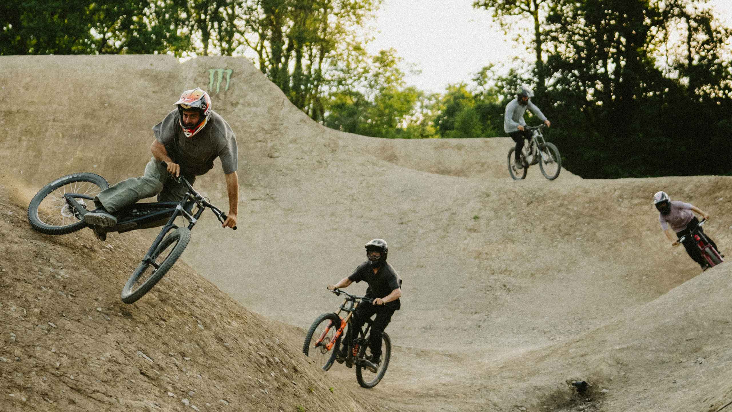 4 bike riders on a track